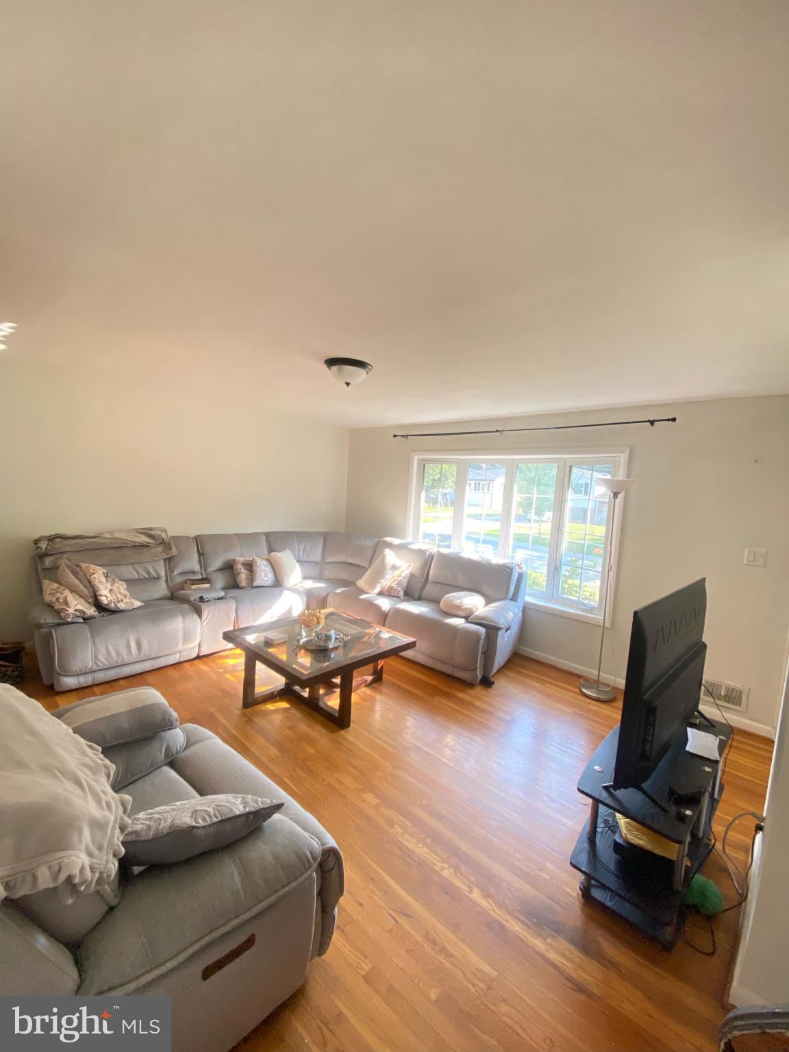 9601 East Light Drive Silver Spring, MD 20903 - Photo 6 of 25 a living room with furniture and a wooden floor