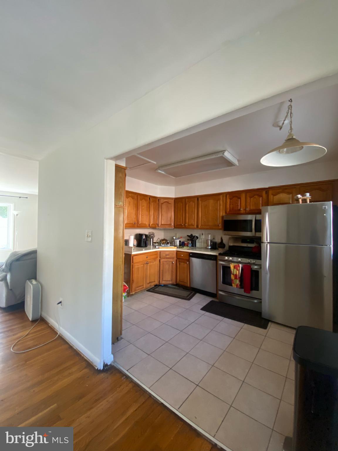 9601 East Light Drive Silver Spring, MD 20903 - Photo 9 of 25 a kitchen with stainless steel appliances a stove and more cabinets