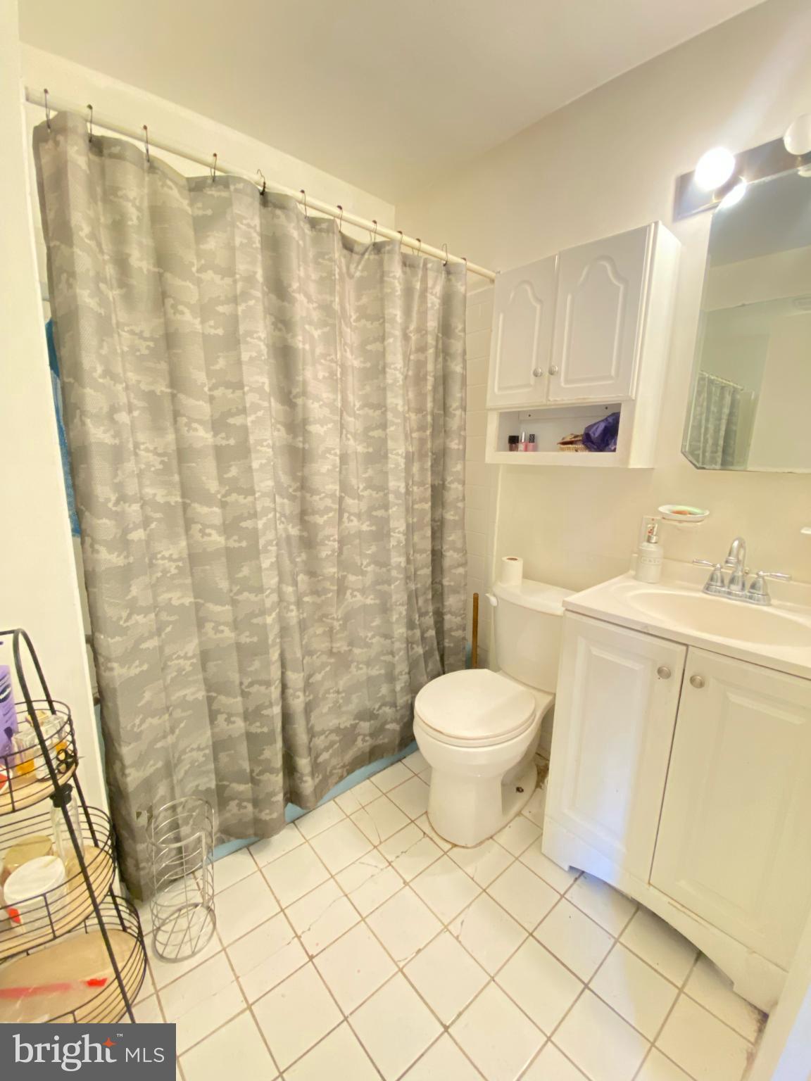 9601 East Light Drive Silver Spring, MD 20903 - Photo 10 of 25 a bathroom with a toilet a sink and a shower