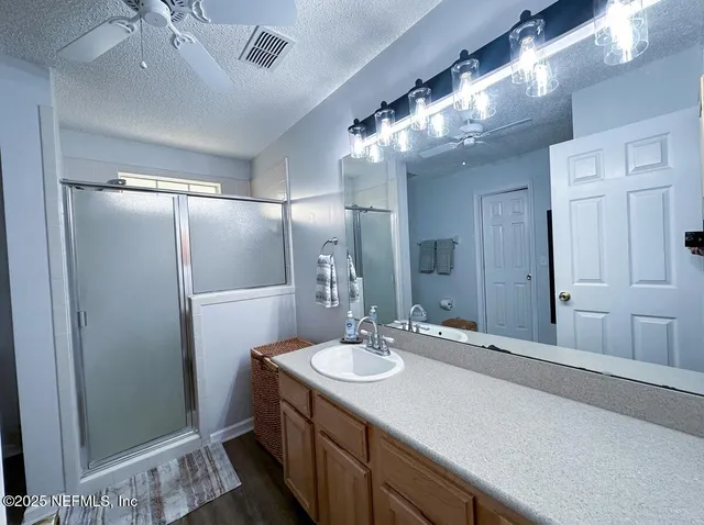 a living room with furniture kitchen view and a wooden floor