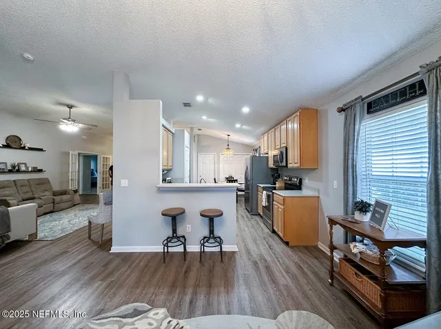 a kitchen with stainless steel appliances granite countertop counter space a sink and a refrigerator