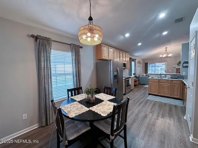 a large kitchen with a table and chairs