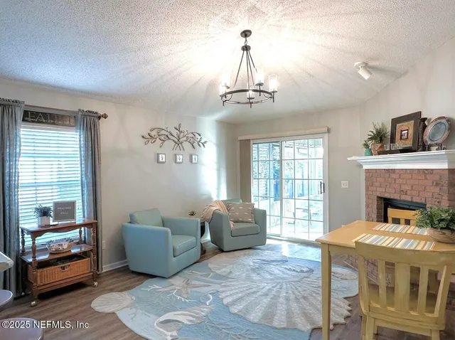 a living room with furniture a fireplace and a table