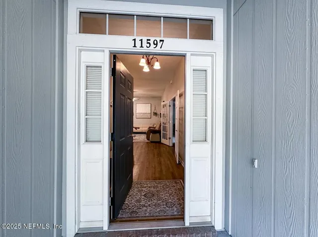 a view of a hallway view with wooden floor and staircase