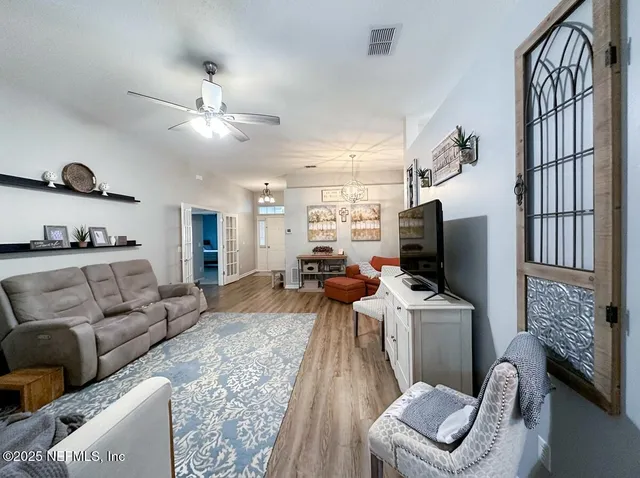 a living room with furniture and a chandelier