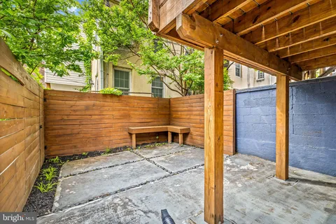 a view of a house with a door and wooden fence