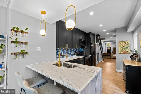 a large kitchen with a table and chairs