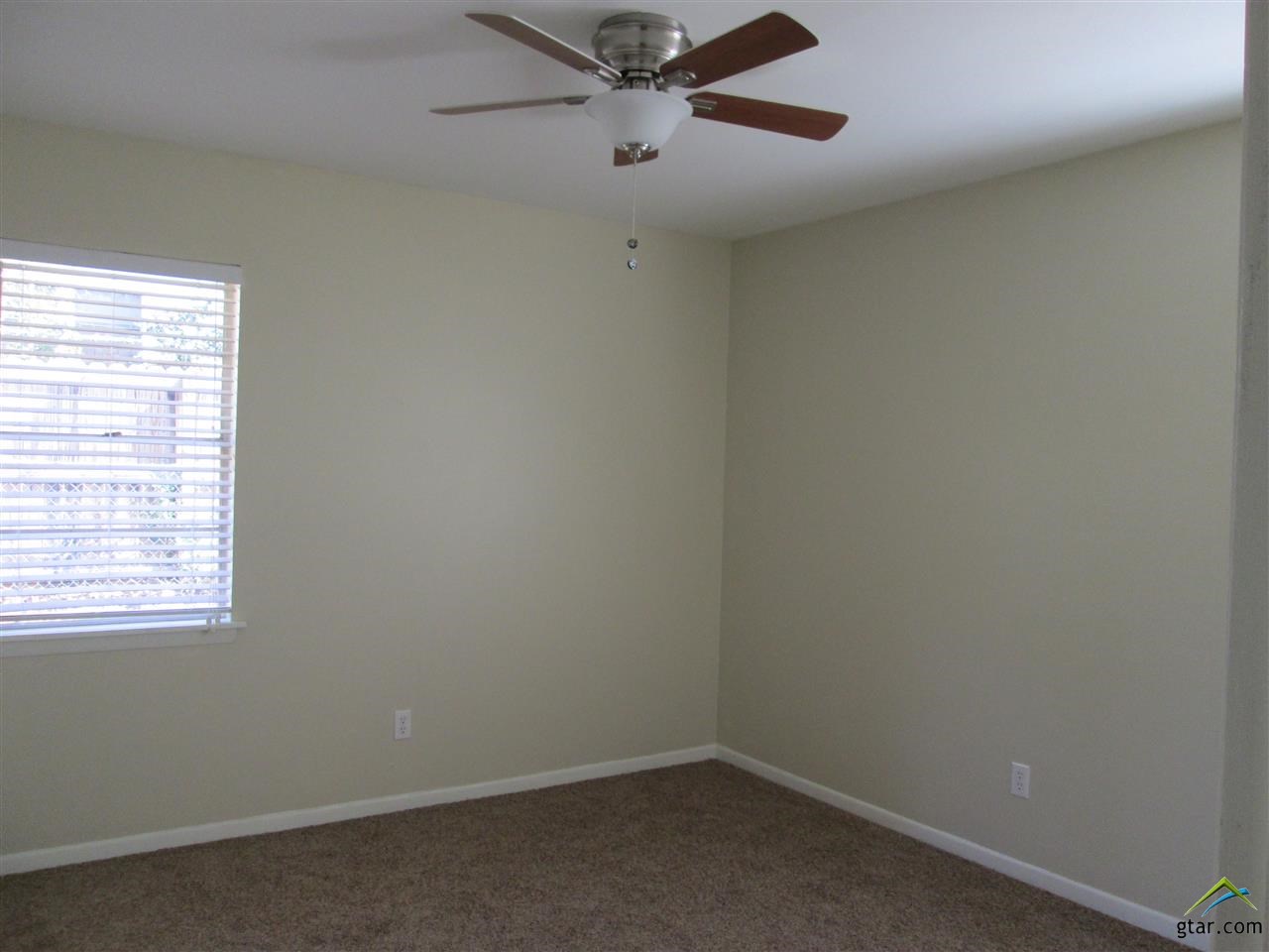 2409 Mimosa Drive Tyler, TX 75701 - Photo 17 of 35 an empty room with a window and a fan