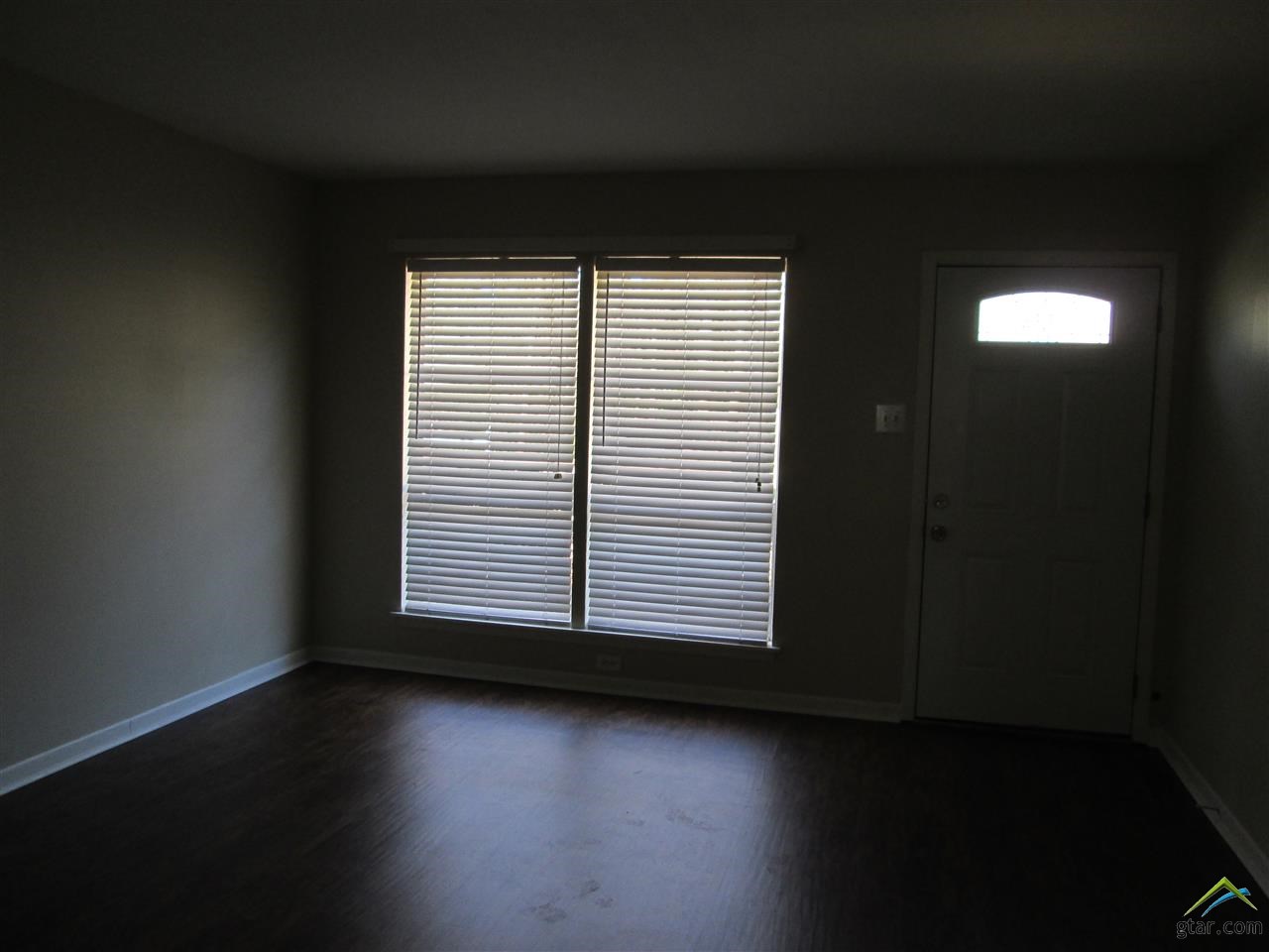 2409 Mimosa Drive Tyler, TX 75701 - Photo 4 of 35 an empty room with wooden floor and a window