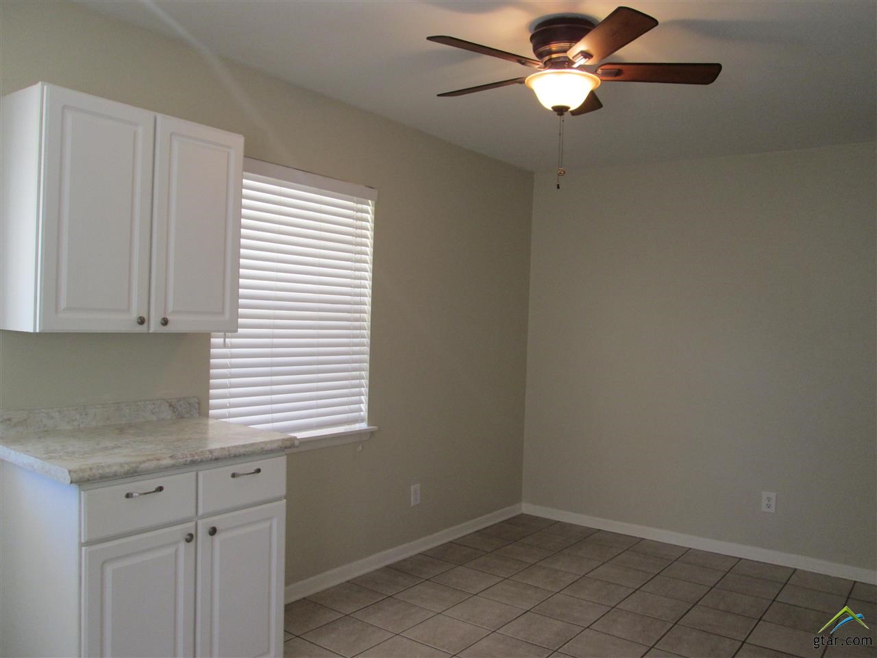 2409 Mimosa Drive Tyler, TX 75701 - Photo 10 of 35 a kitchen with a cabinets window and a ceiling fan