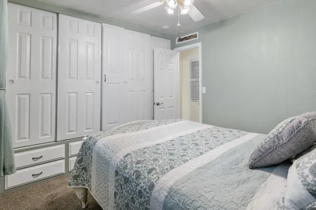 a bathroom with a granite countertop sink a toilet and shower
