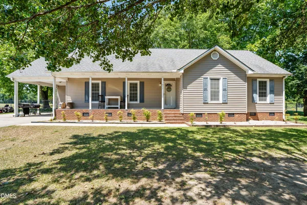 a front view of house with yard and outdoor seating