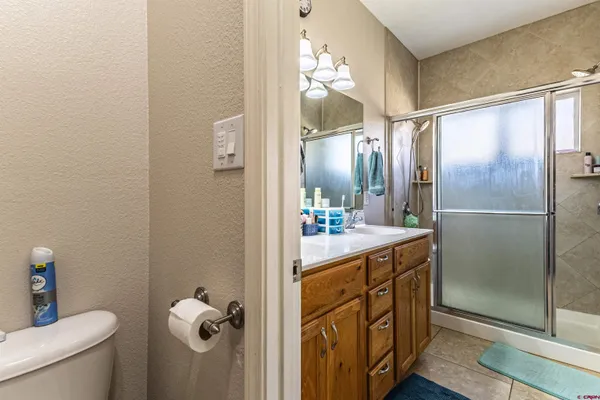 a bathroom with a double vanity sink mirror and toilet
