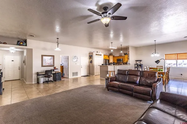 a living room with furniture and kitchen view
