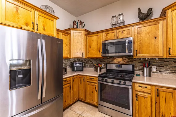 a kitchen with stainless steel appliances a stove microwave and a refrigerator