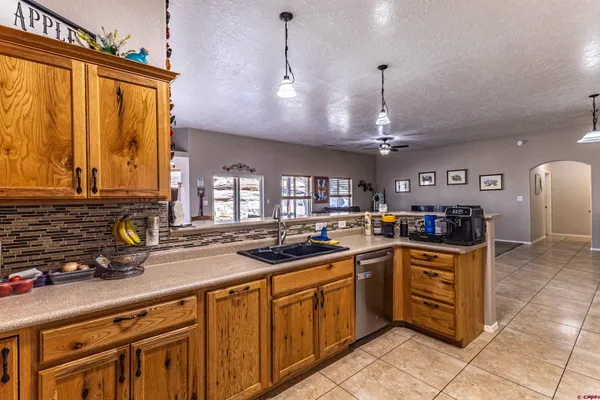 a kitchen with stainless steel appliances granite countertop a sink and cabinets