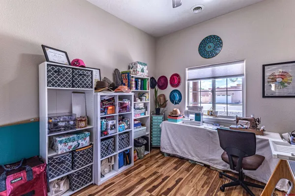 a living room with furniture a bookshelf and a window
