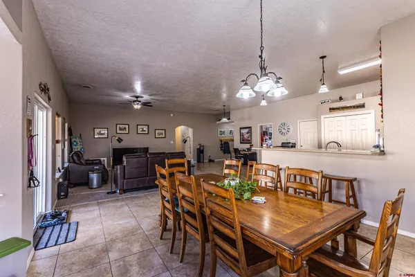 a view of a dining room with furniture and chandelier