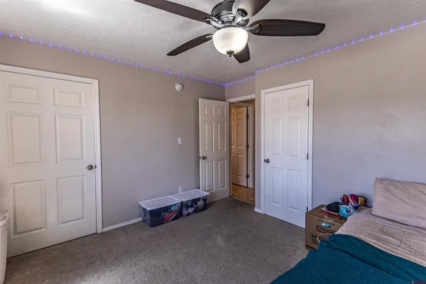 a living room with furniture and a ceiling fan