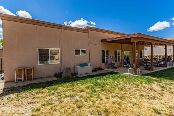 a view of a house with backyard porch and sitting area