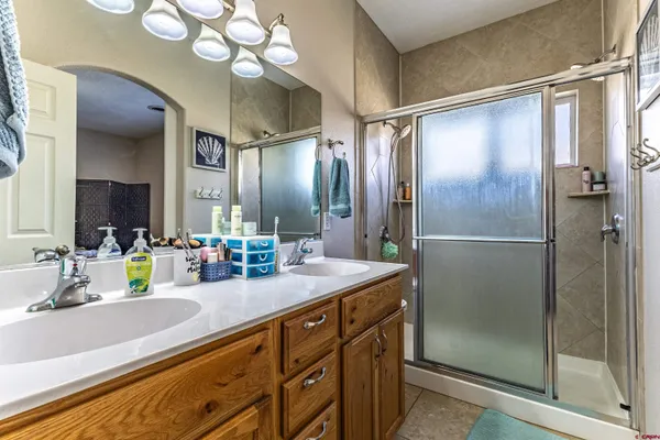 a bathroom with a granite countertop sink mirror and shower