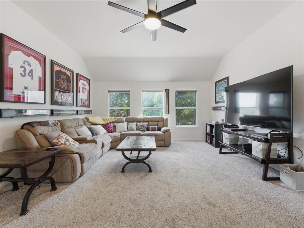4008 Falcon Ridge Drive Haltom City, TX 76137 - Photo 20 of 40 Spacious carpeted room featuring a vaulted ceiling with a ceiling fan, multiple windows, and ample wall space