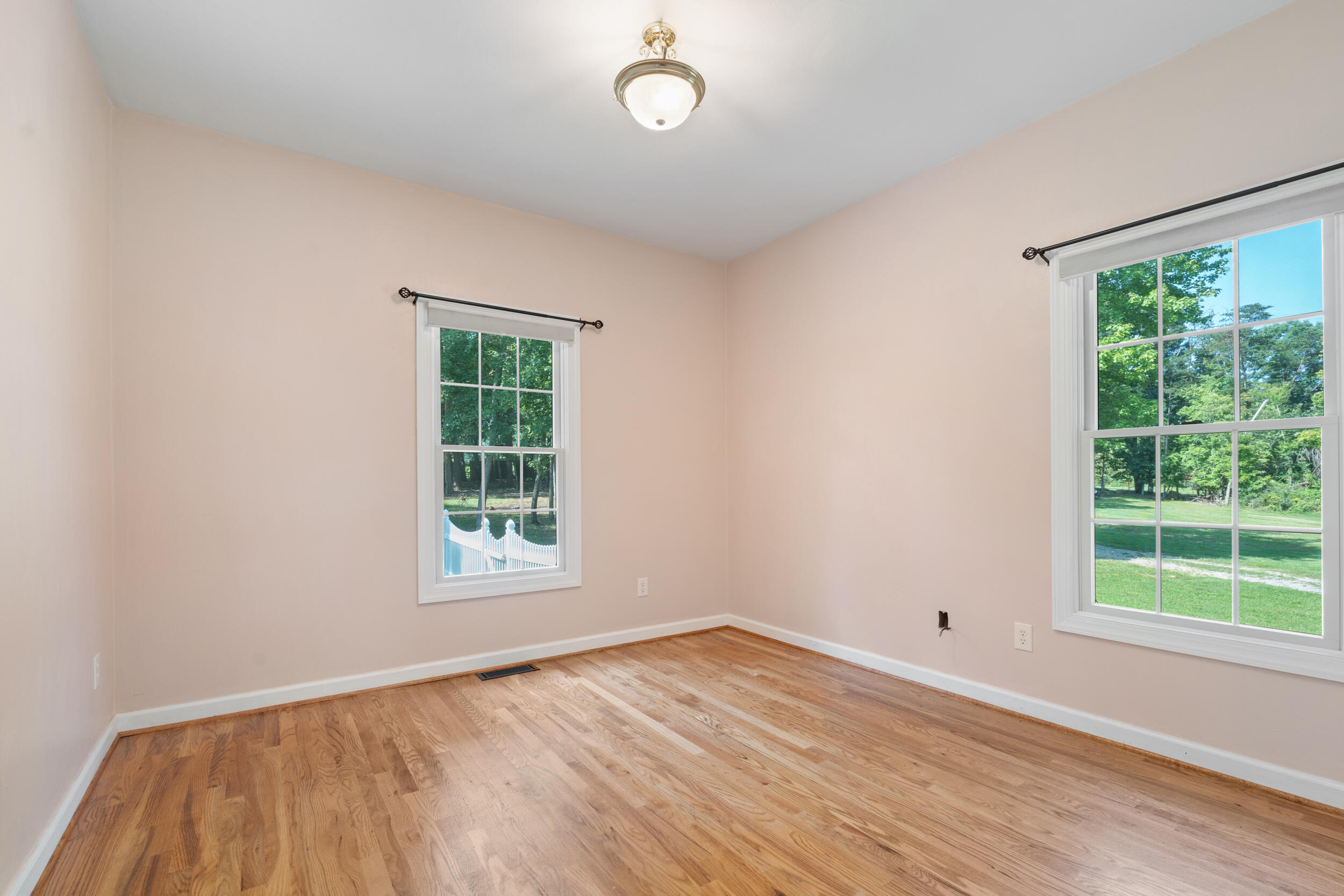 4731 Goodman Road Roanoke, VA 24014 - Photo 29 of 47 an empty room with wooden floor and windows