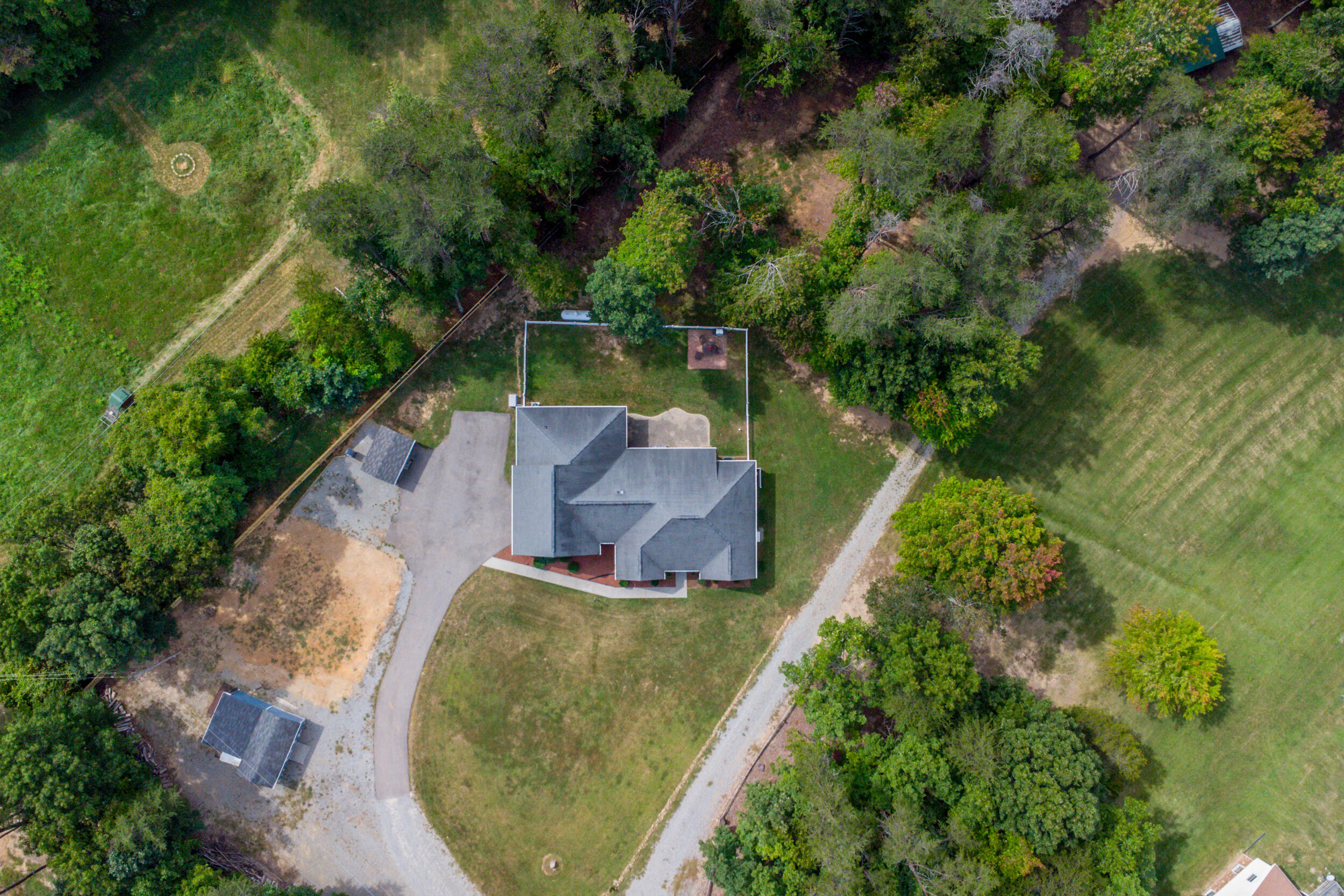 4731 Goodman Road Roanoke, VA 24014 - Photo 46 of 47 an aerial view of a house with a yard lake and trees all around