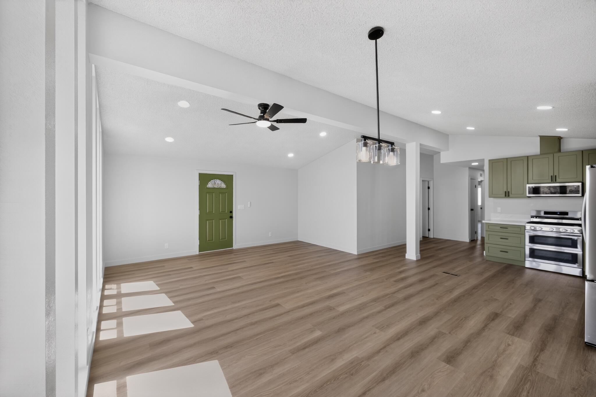 15181 Van Buren Boulevard, Unit 102 Riverside, CA 92504 - Photo 6 of 29 a view of empty room with wooden floor and ceiling fan