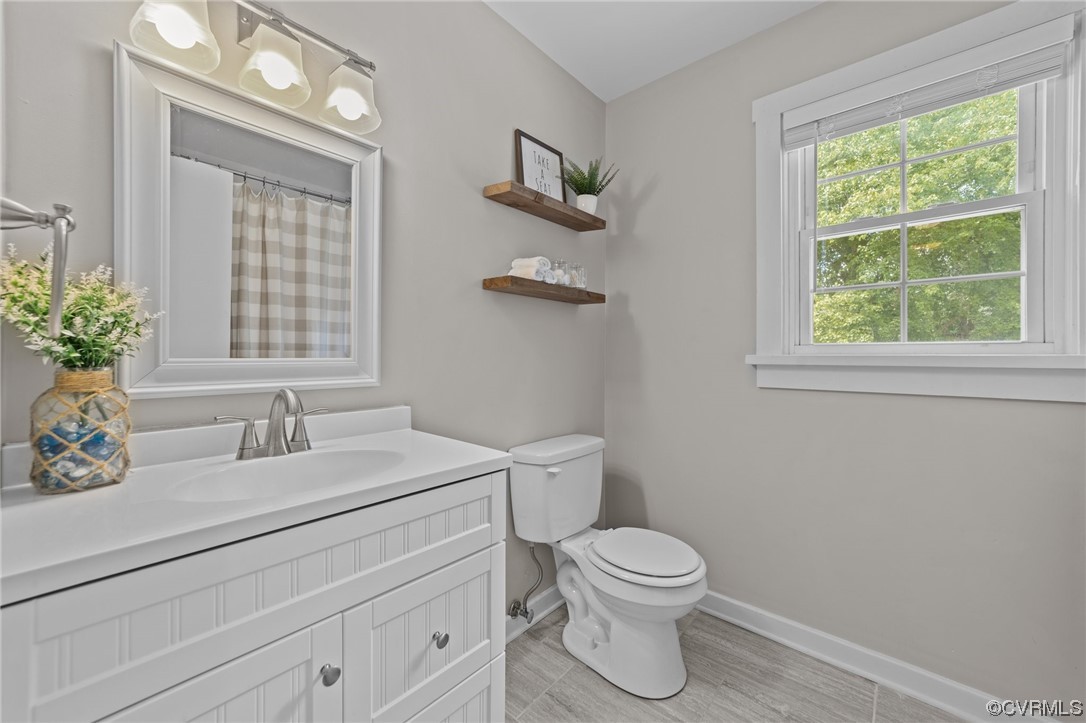4513 Brookridge Road Chesterfield, VA 23832 - Photo 5 of 50 a bathroom with a toilet sink and mirror