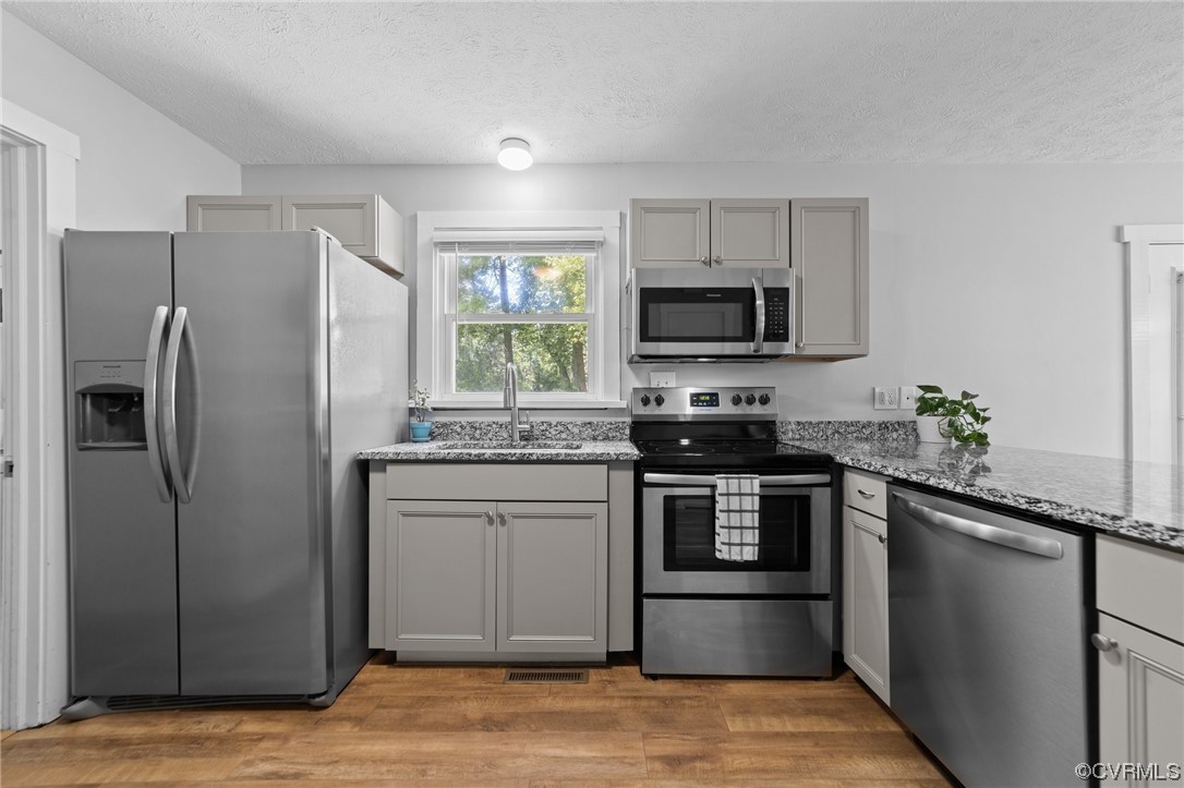 4513 Brookridge Road Chesterfield, VA 23832 - Photo 6 of 50 a kitchen with stainless steel appliances granite countertop a refrigerator stove and microwave