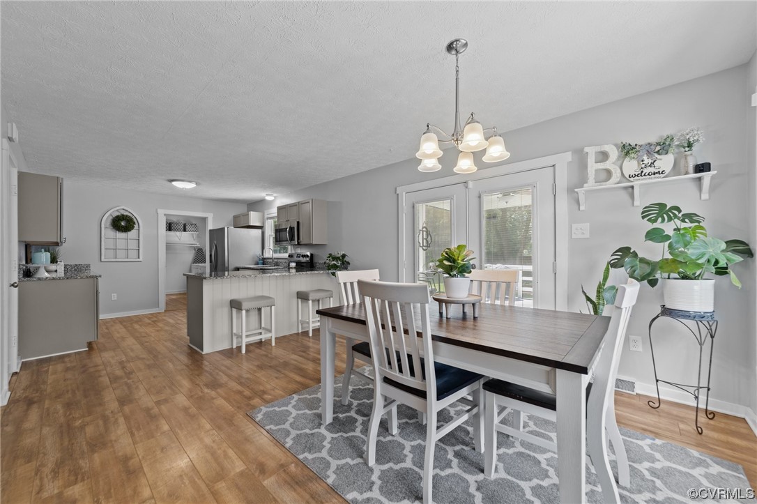 4513 Brookridge Road Chesterfield, VA 23832 - Photo 7 of 50 a view of a dining room with furniture and a chandelier