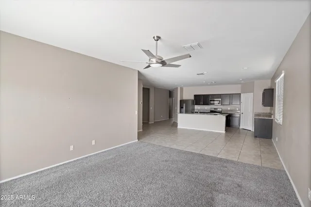 a view of a kitchen with a sink and dishwasher a refrigerator with white cabinets