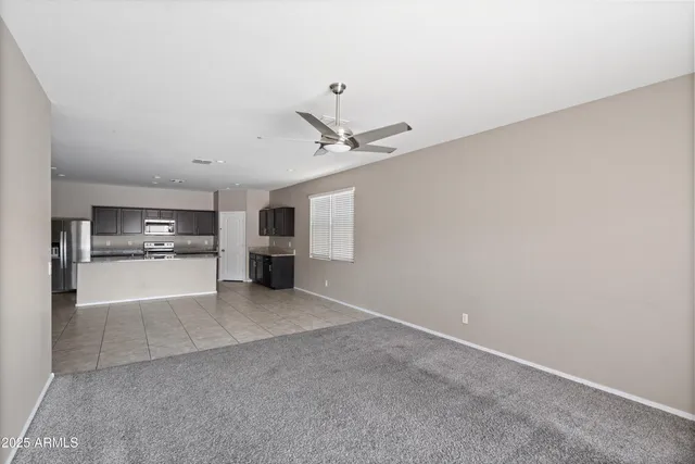 a view of a livingroom with a kitchen and a stove