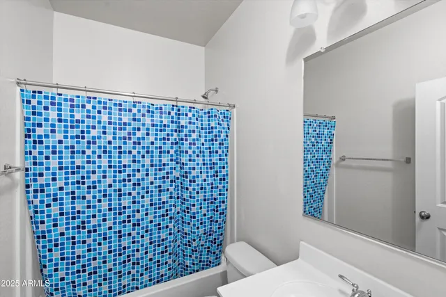 a bathroom with a black and white shower curtain