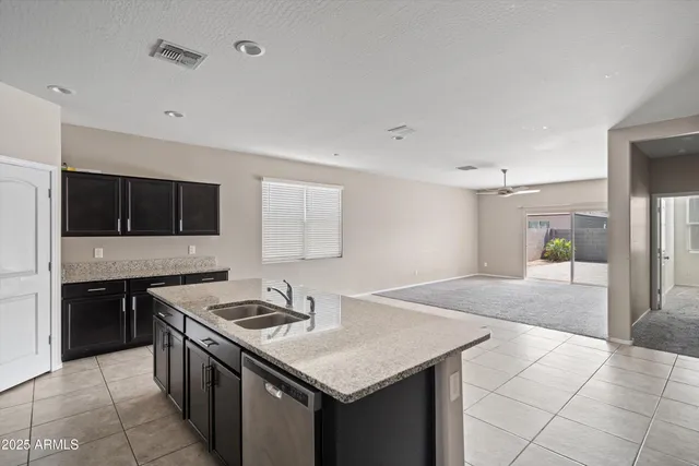 a kitchen with a stove a sink and a refrigerator