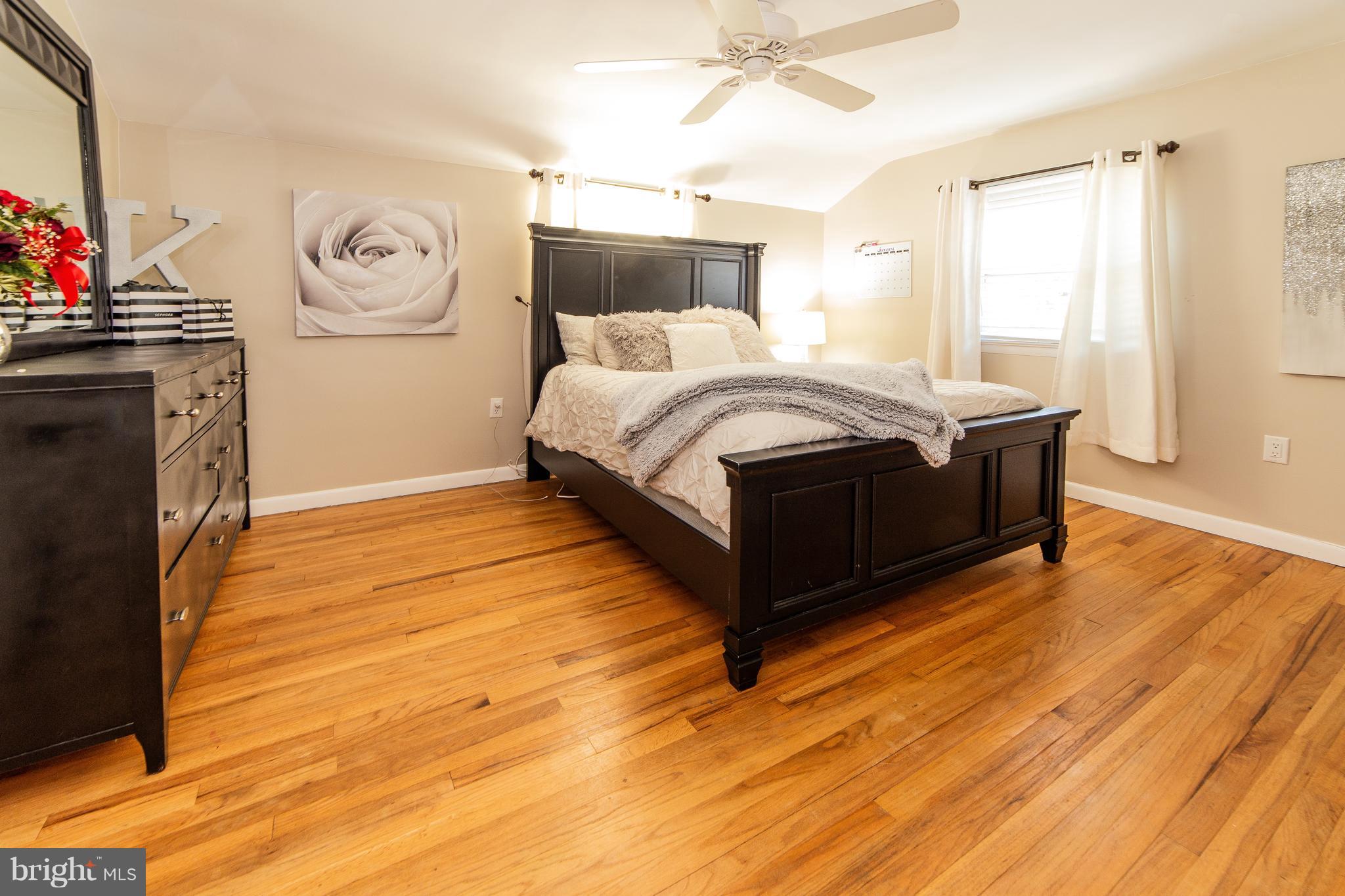 414 Franklin Road Glassboro, NJ 08028 - Photo 14 of 17 a bedroom with a bed and wooden floor