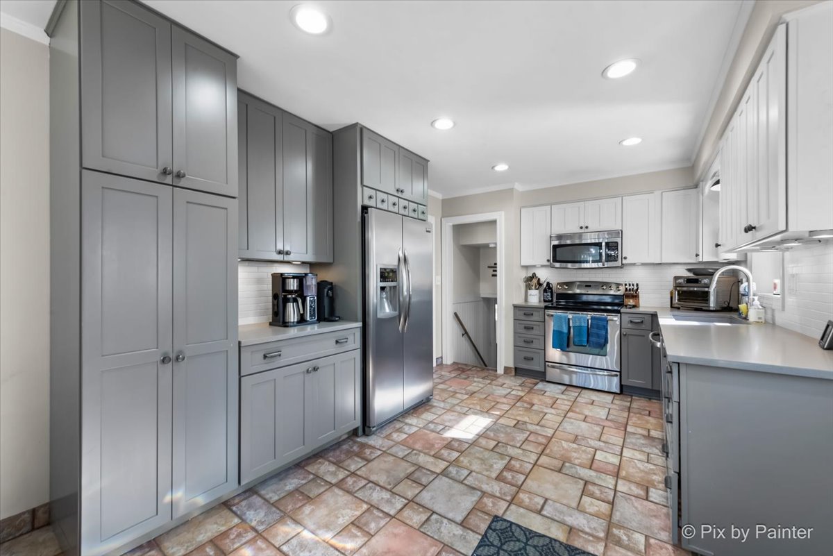 571 Lowden Avenue Glen Ellyn, IL 60137 - Photo 13 of 30 a kitchen with stainless steel appliances granite countertop a refrigerator and a stove top oven
