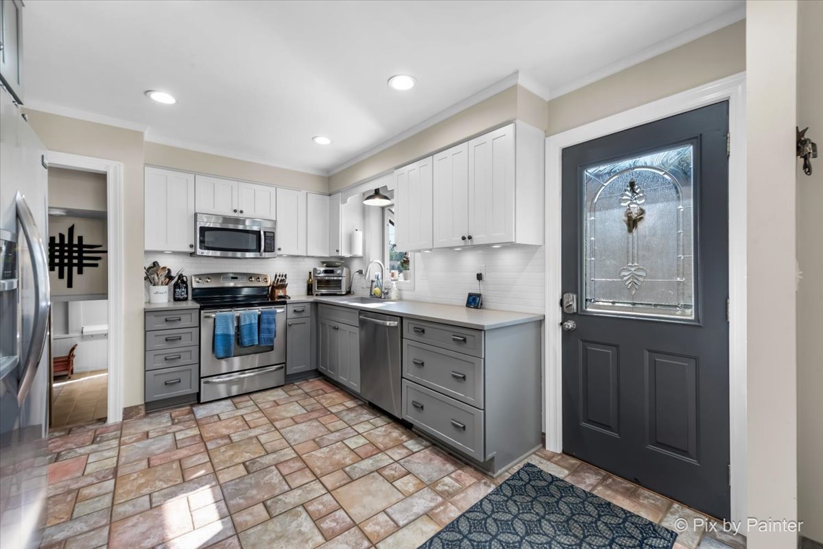 571 Lowden Avenue Glen Ellyn, IL 60137 - Photo 14 of 30 a kitchen with granite countertop a refrigerator stove top oven and sink