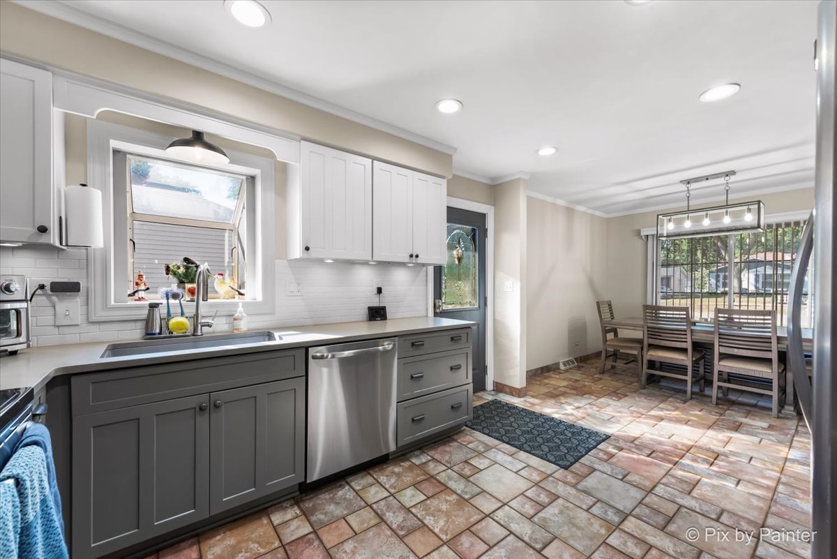 571 Lowden Avenue Glen Ellyn, IL 60137 - Photo 15 of 30 a kitchen with a sink and chairs