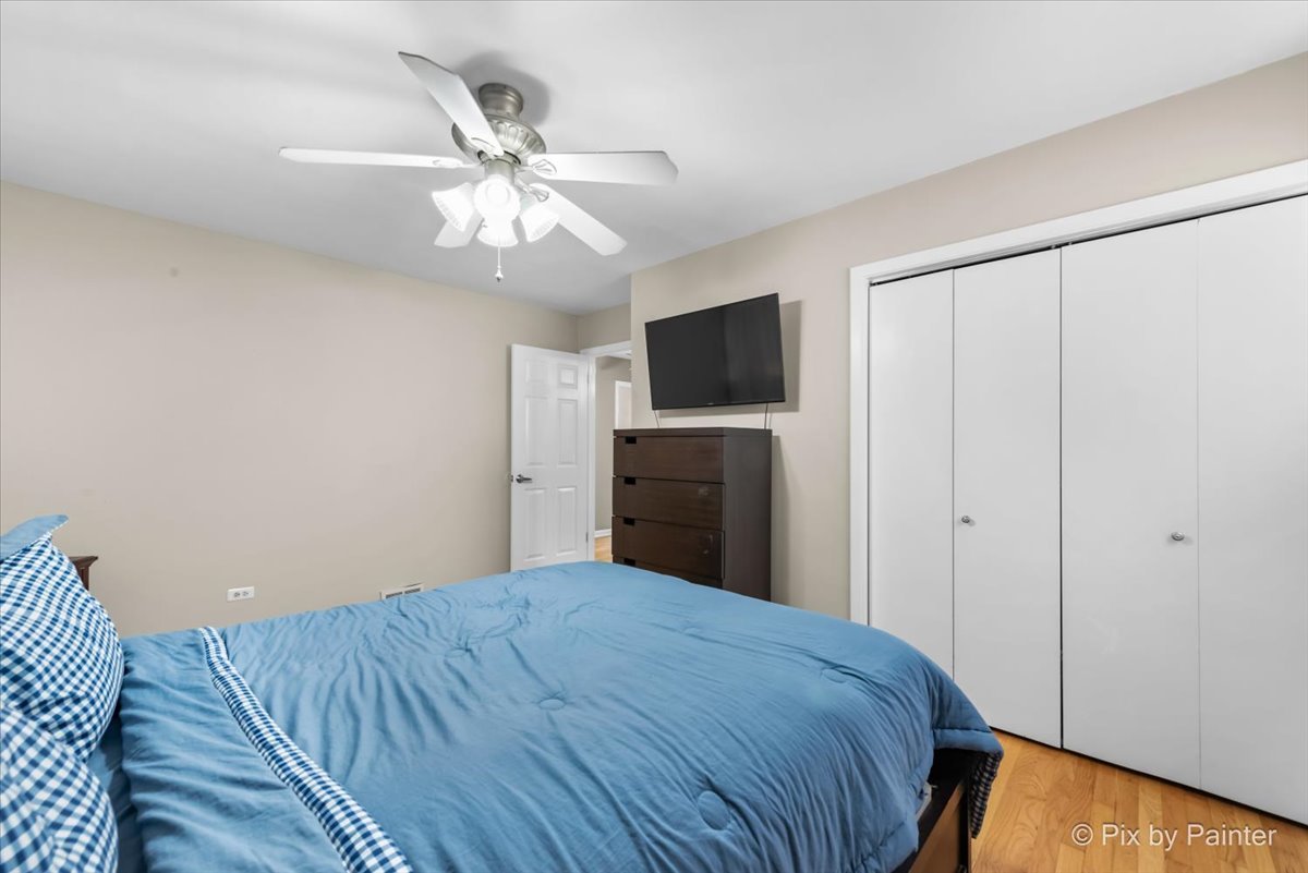 571 Lowden Avenue Glen Ellyn, IL 60137 - Photo 21 of 30 a bedroom with a bed and a flat tv screen on dresser