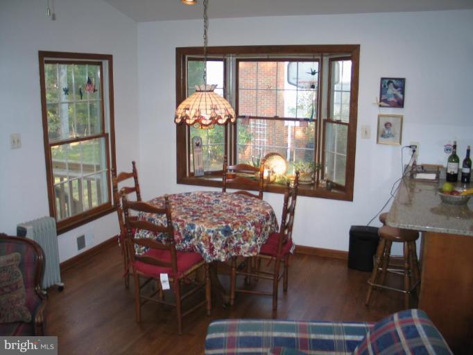 1007 Loxford Terrace Silver Spring, MD 20901 - Photo 12 of 15 a view of a dining room with furniture a chandelier and wooden floor