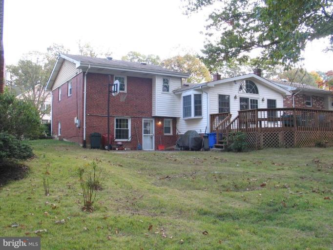 1007 Loxford Terrace Silver Spring, MD 20901 - Photo 4 of 15 a view of a yard in front of a house with large trees