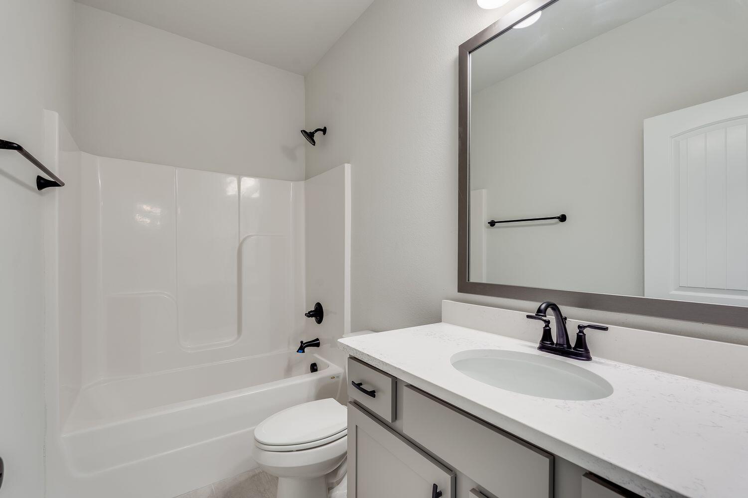 77 Eclipse Loop Freeport, FL 32439 - Photo 23 of 31 a bathroom with a sink a toilet and a large mirror