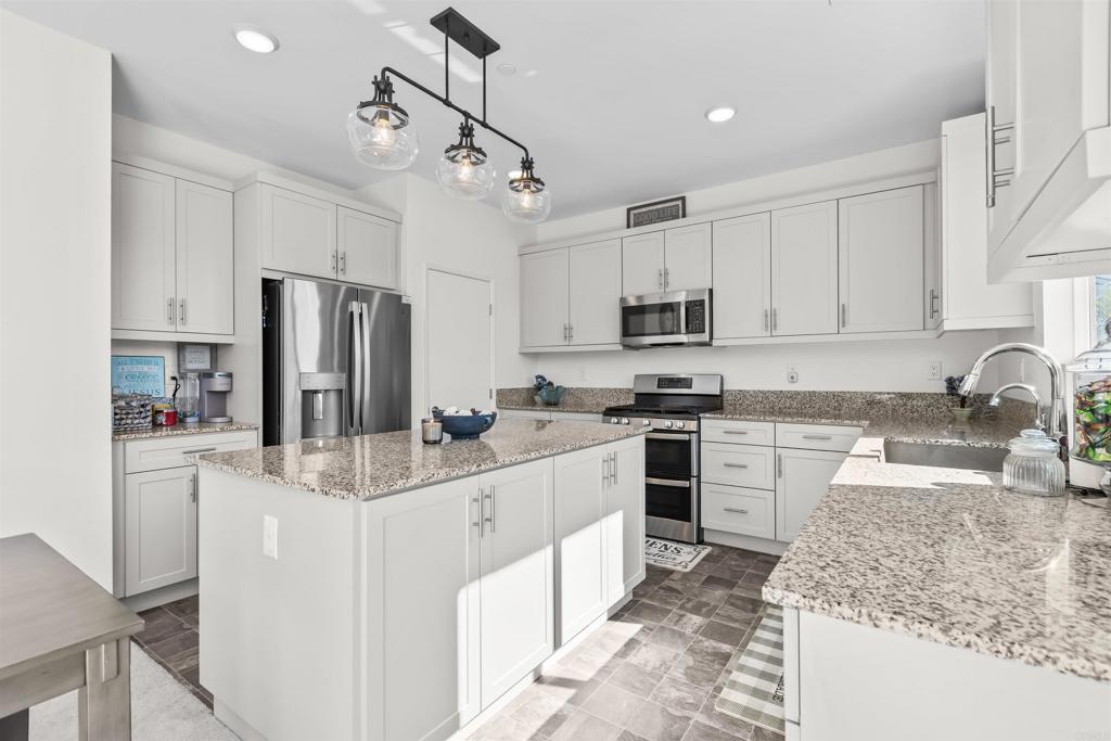 35076 Hacienda Heights Fallbrook, CA 92028 - Photo 11 of 32 a kitchen with stainless steel appliances granite countertop a sink stove refrigerator and cabinets