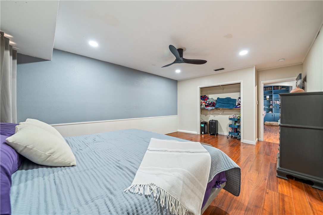 2217 Post Oak Drive Portland, TX 78374 - Photo 19 of 39 a bedroom with a bed and a large mirror with wooden floor