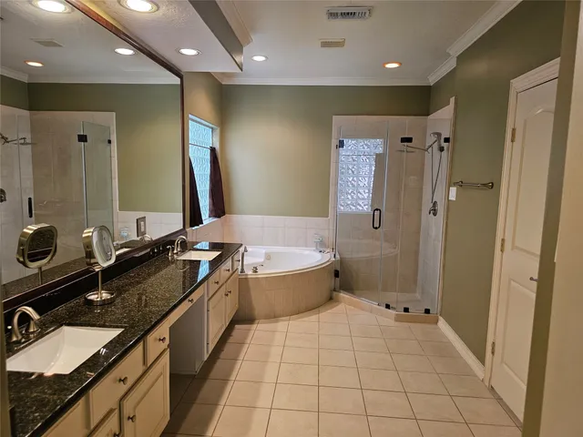 a spacious bathroom with a granite countertop sink a toilet a mirror and shower