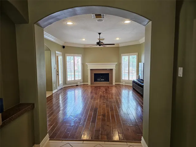 wooden floor in an empty room with a fireplace