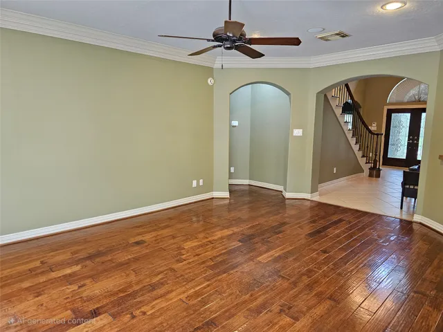 a view of empty room with wooden floor