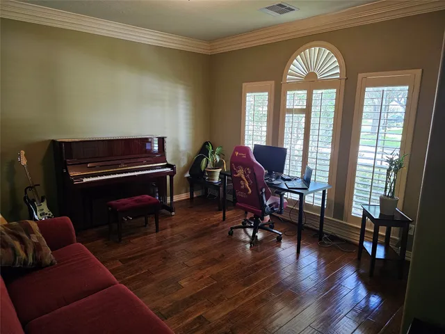 a living room with furniture fireplace and wooden floor